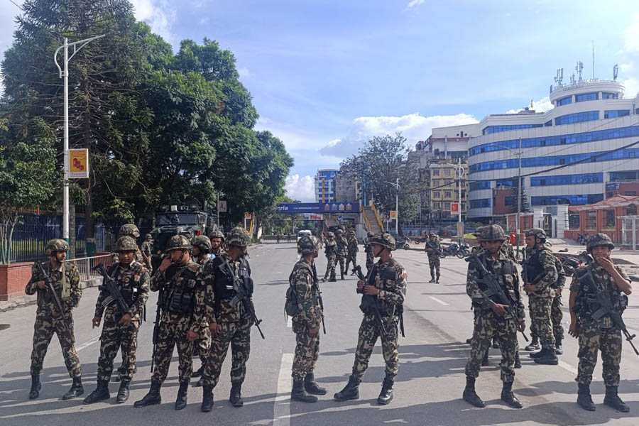 Nepal Army and police officers patrol Kathmandu Valley streets during curfew and prohibition hours for citizen safety.