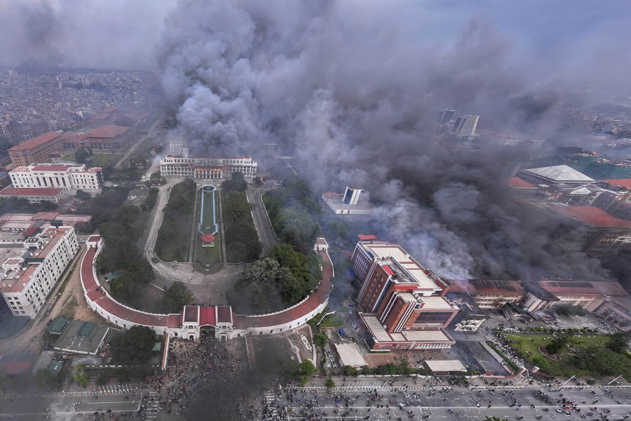Burnt vehicles in front of Nepal’s Supreme Court with temporary tents set up to continue judicial services.