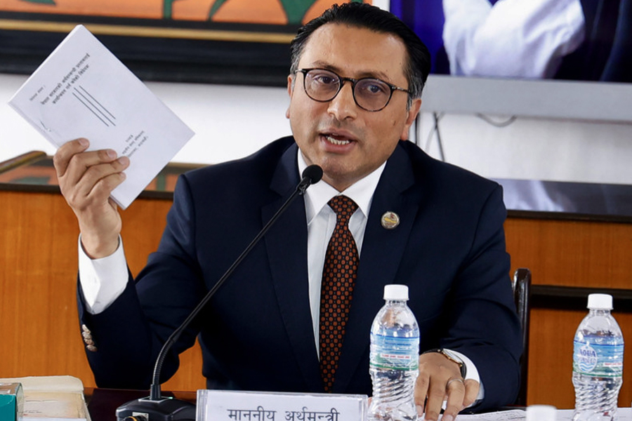 Finance Minister Dr. Swarnim Wagle speaking at a parliamentary committee meeting, challenging critics to prove allegations of tax-related misconduct