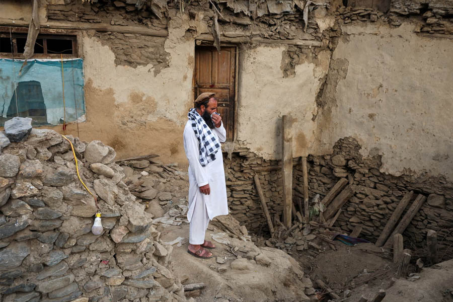 Afghan man stands among collapsed rubble after deadly 6.0 earthquake in Kunar province, Afghanistan.