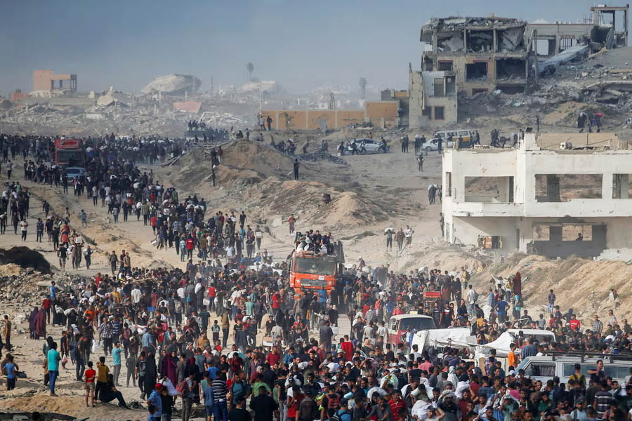 Palestinians gather to receive aid supplies in Beit Lahia on Sunday.