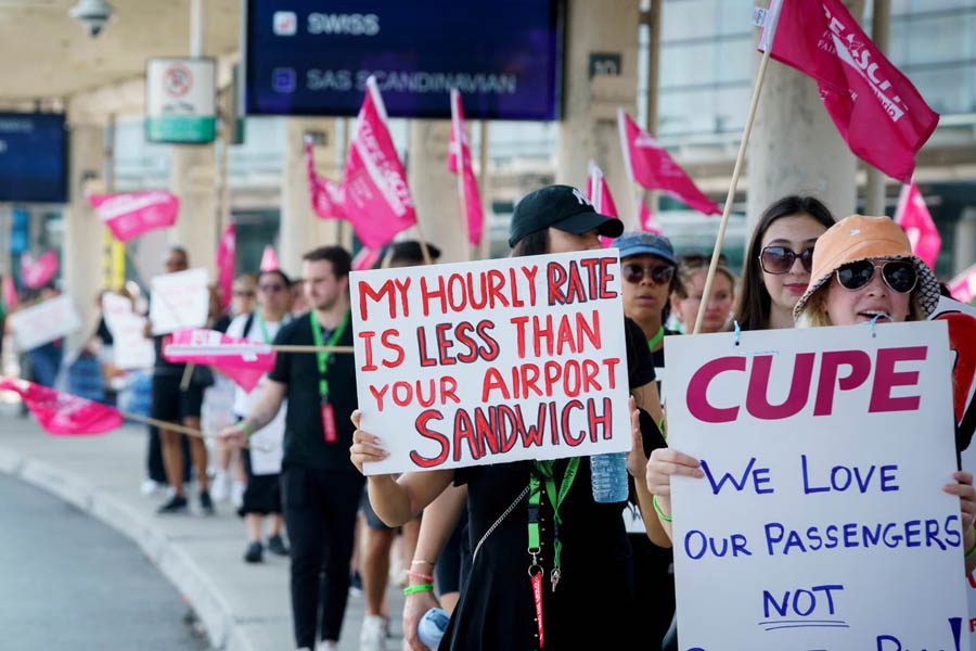 Air Canada flight attendants stand on a picket line at Pearson International Airport, Toronto, on Saturday during a strike that left thousands of travellers stranded.