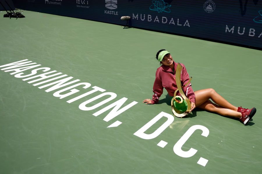 Alexandra Eala poses with her trophy after beating Jessica Pegula