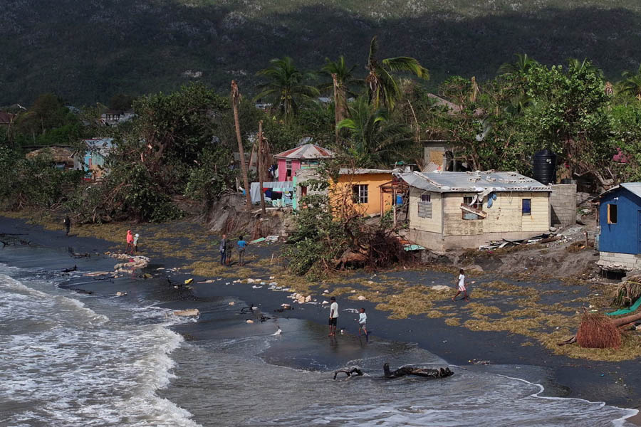 Severely damaged coastal houses in Alligator Pond, Jamaica, showing debris and destruction caused by Hurricane Melissa’s powerful storm surge and high winds.
