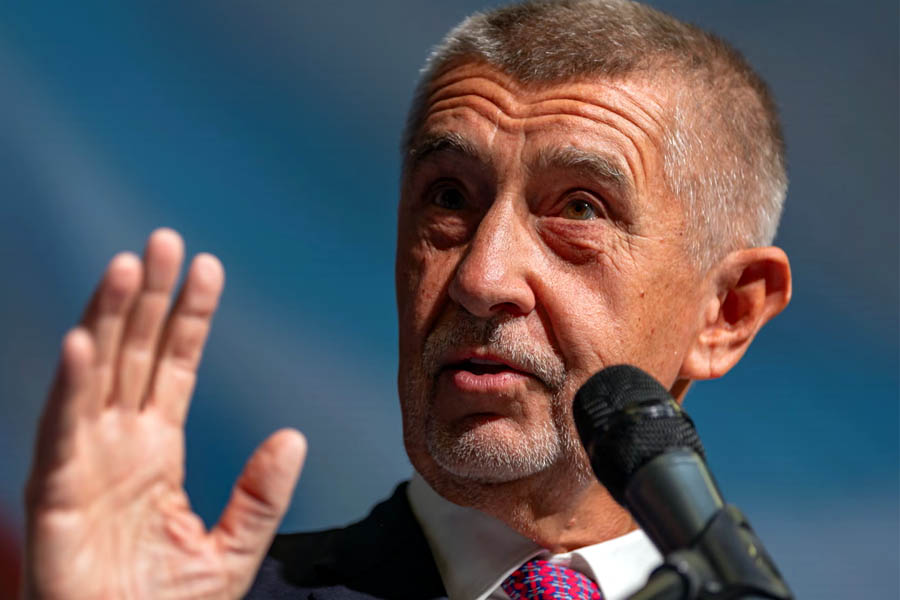 Andrej Babiš speaking at a podium in Prague after his election victory, raising concerns about Ukraine support and NATO defence spending.