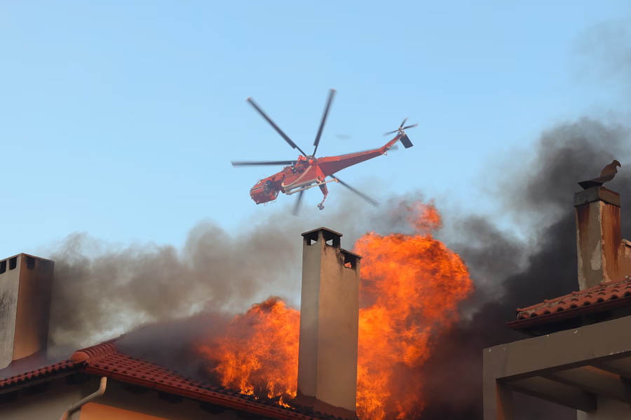 Flames engulf homes in Athens and Aude as Europe battles relentless wildfires and forced evacuations amid extreme heat.