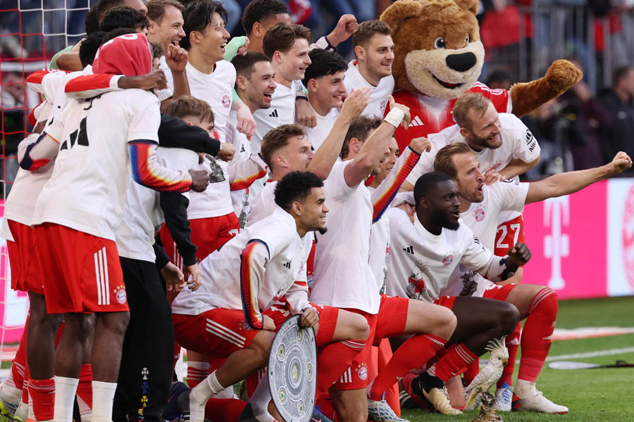 Bayern Munich players celebrate clinching the Bundesliga title with four matches remaining after a dominant season.