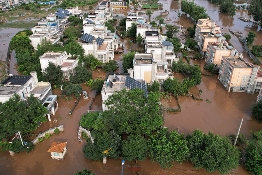 An aerial view shows submerged residential buildings after heavy rains and flooding in Taishitun village, Miyun district, on the outskirts of Beijing, China.