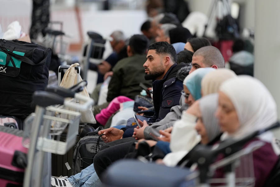 Passengers sitting and standing in the departure terminal of Rafik Hariri International Airport in Beirut, Lebanon, following widespread flight cancellations.