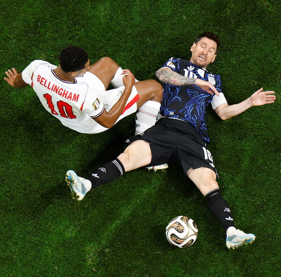 Jude Bellingham collides with Lionel Messi during a fractious first half