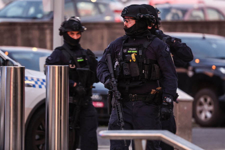 Armed police working at Bondi Beach after a mass shooting that killed at least 12 people in an attack targeting Sydney’s Jewish community.