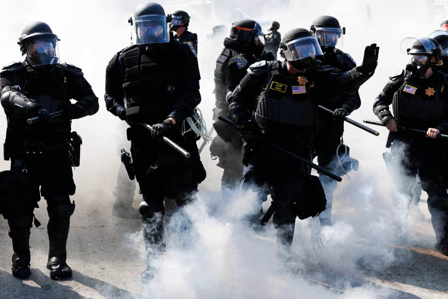 California highway patrol using smoke grenades to advance and push protestors off the 101 freeway during a demonstration following federal immigration operations in Los Angeles.