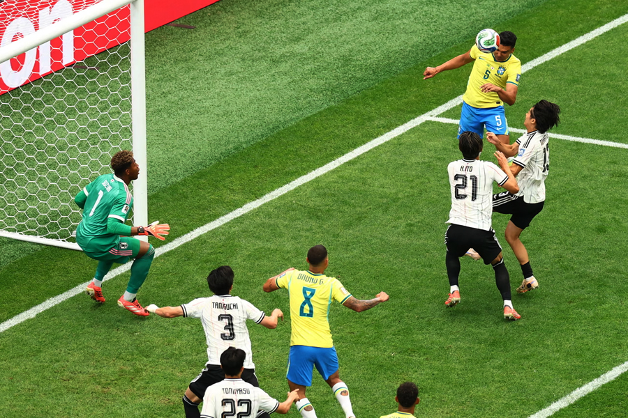 Brazil's Casemiro scores their first goal against Japan with a powerful header