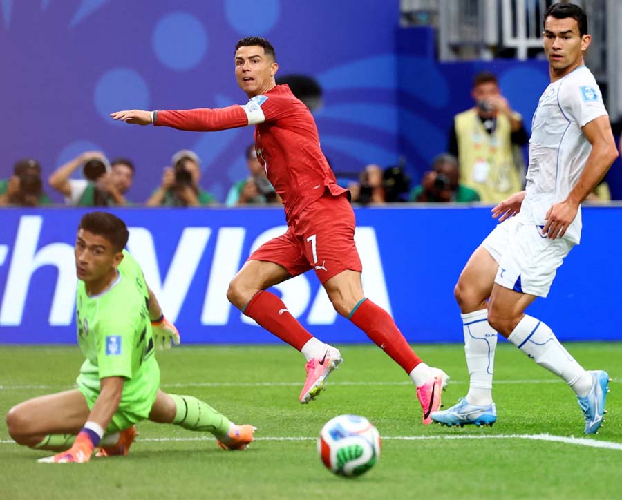 Cristiano Ronaldo passes the ball into the net for his second, and Portugal's third, goal of the game