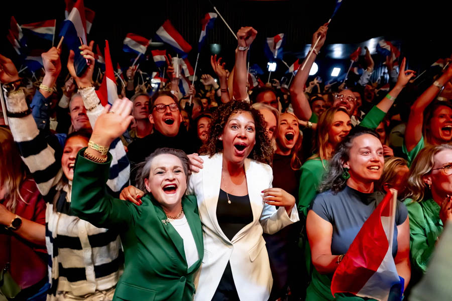 Excited D66 supporters celebrating in Leiden after exit polls show their party leading in the Dutch election, marking a potential turning point in Netherlands politics.