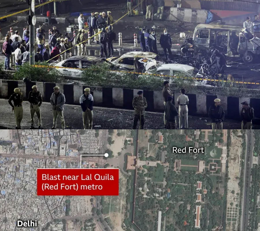 Fire engines and police at the scene of a car explosion near the Red Fort in Delhi, with smoke and damaged vehicles visible.