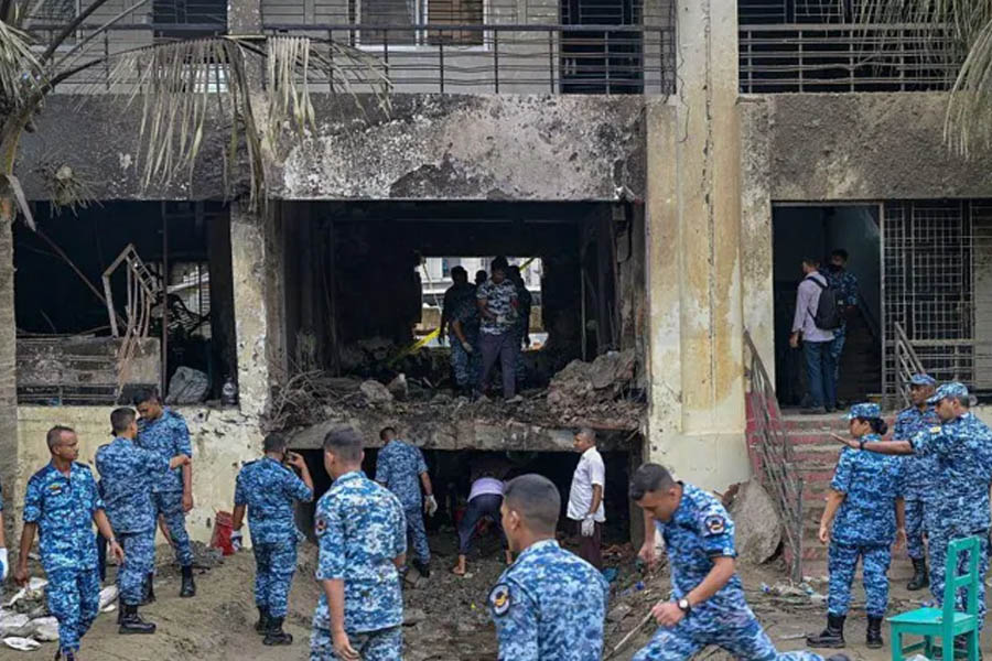 Emergency responders sift through the wreckage of Milestone School and College in Dhaka after a Bangladesh Air Force F-7 jet crashed, killing at least 27, including 17 children.