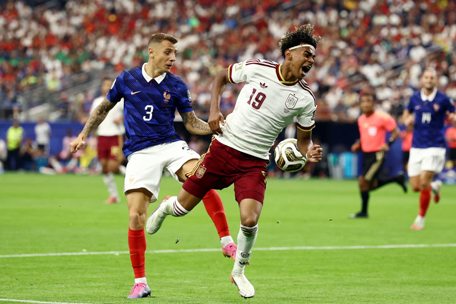 France's Lucas Digne concedes a penalty for a wild kick at Spain's Lamine Yamal