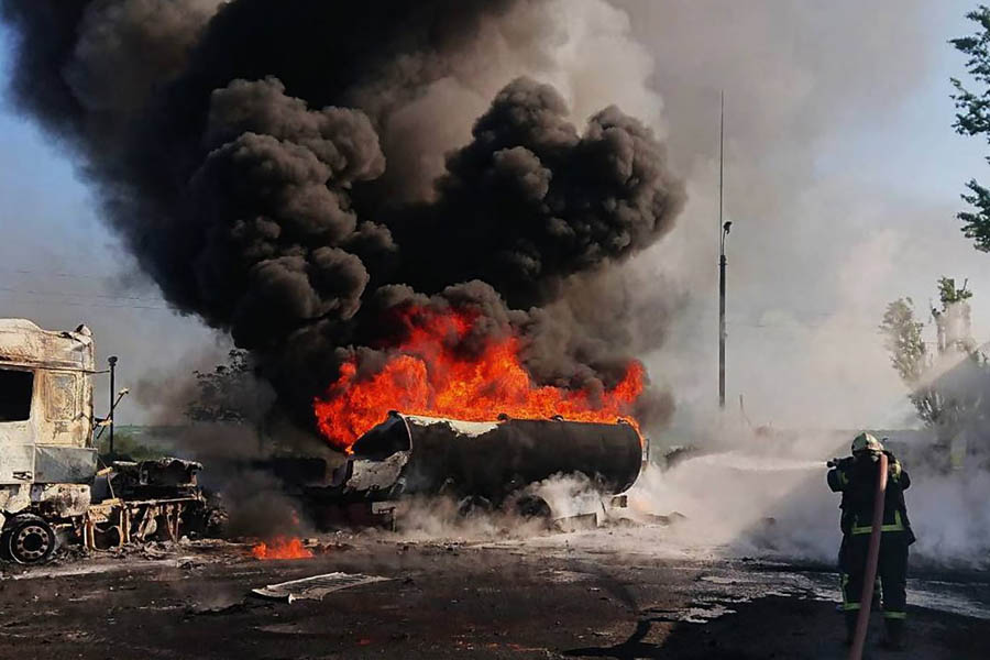 A firefighter tries to put out a blaze after an air attack in Dnipro, in a photograph released by Ukrainian emergency services.
