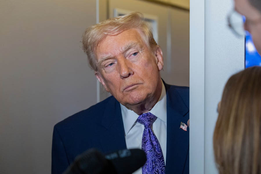 Donald Trump speaking with reporters aboard Air Force One during an in-flight press briefing on Sunday.