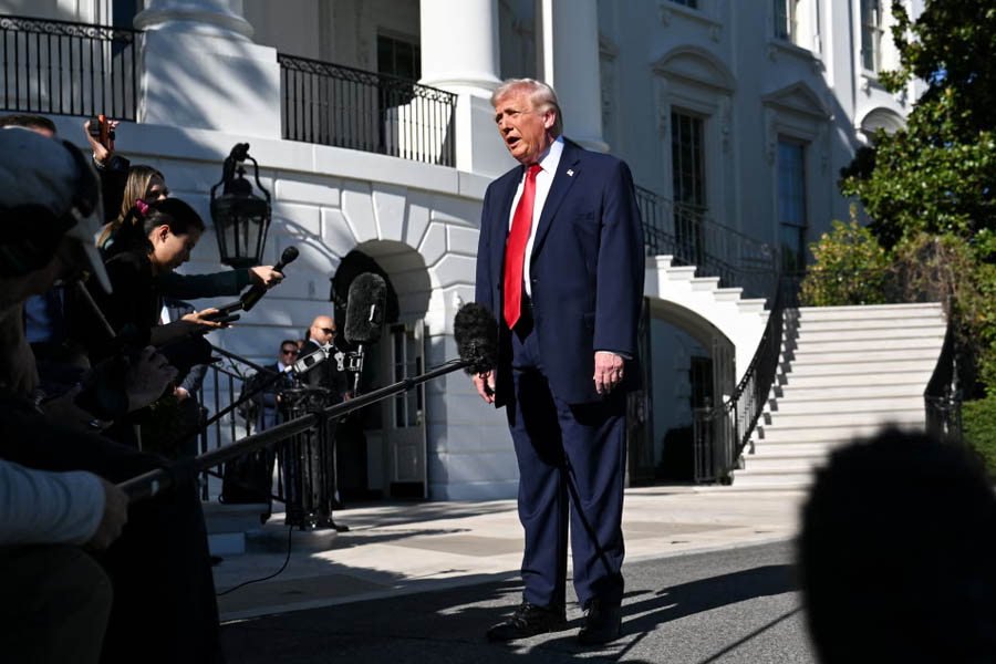Donald Trump speaks to the press as he departs from the White House in Washington, DC on 11 April.