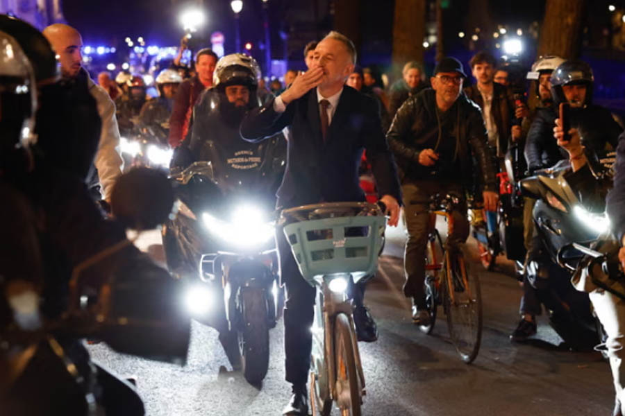 Emmanuel Grégoire riding a bicycle in Paris after being elected mayor, highlighting eco-friendly transport and green city initiatives