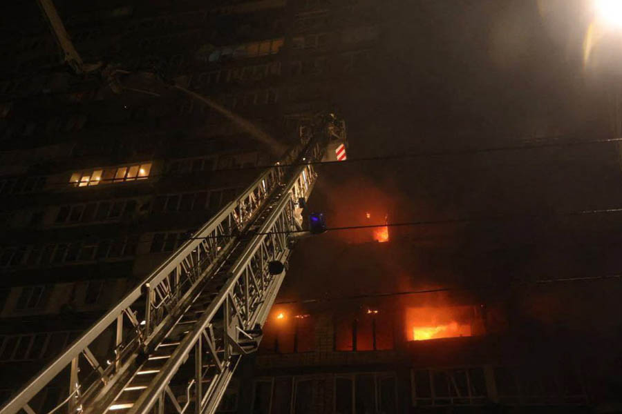 Firefighters work to extinguish fires in a high-rise apartment building in Kyiv following a Russian missile and drone attack that caused blackouts and destruction.