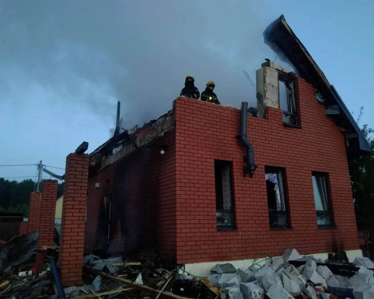 Firefighters work at a damaged residential house after a Ukrainian drone attack in the Moscow region. At least three people were killed in the capital region during the overnight assault.
