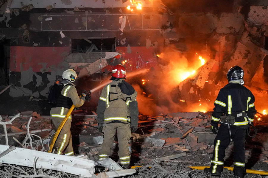 Firefighters working at the site of an overnight Russian strike in Poltava, Ukraine