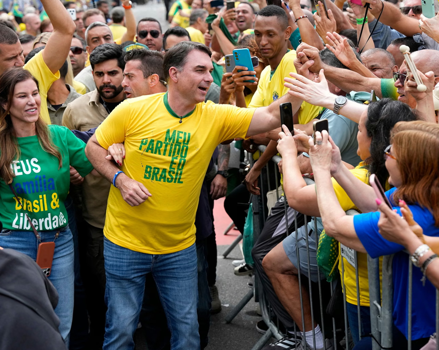 Flávio Bolsonaro and his wife, Fernanda Bolsonaro, arrive for his campaign launch event at Rio's Copacabana beach
