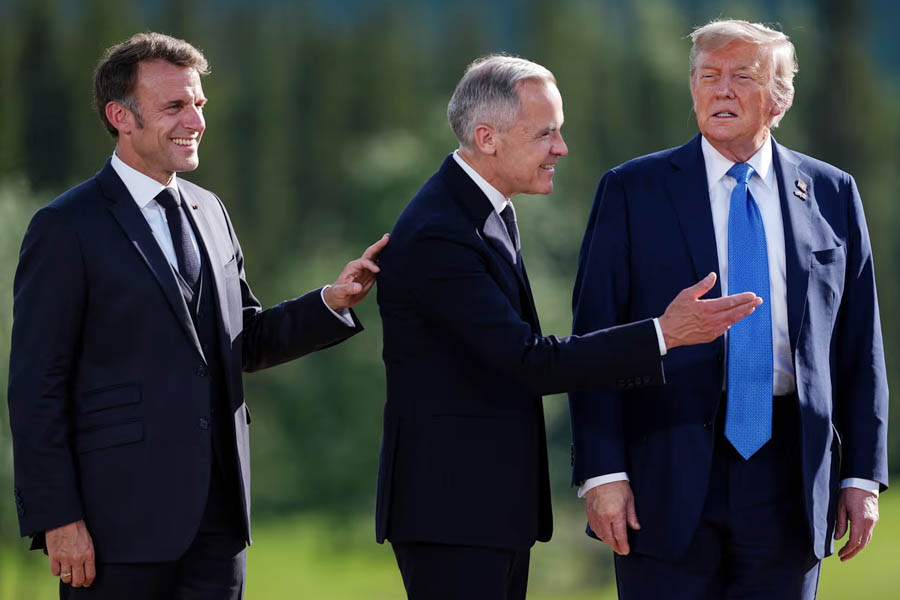 French President Emmanuel Macron, left, Canadian prime minister Mark Carney, centre, and US President Donald Trump.
