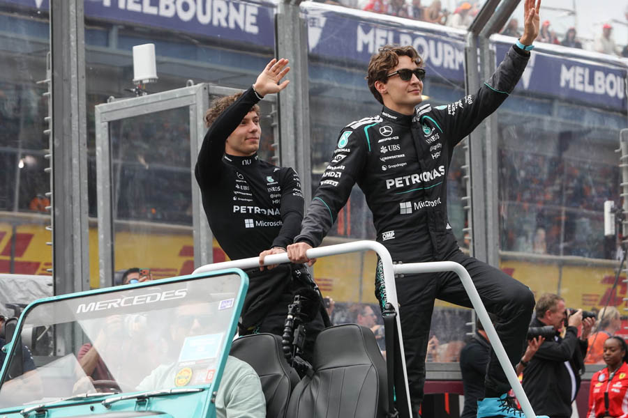 George Russell and Kimi Antonelli standing beside their Mercedes Formula 1 cars after securing a dominant one-two finish at the Australian Grand Prix in Melbourne.