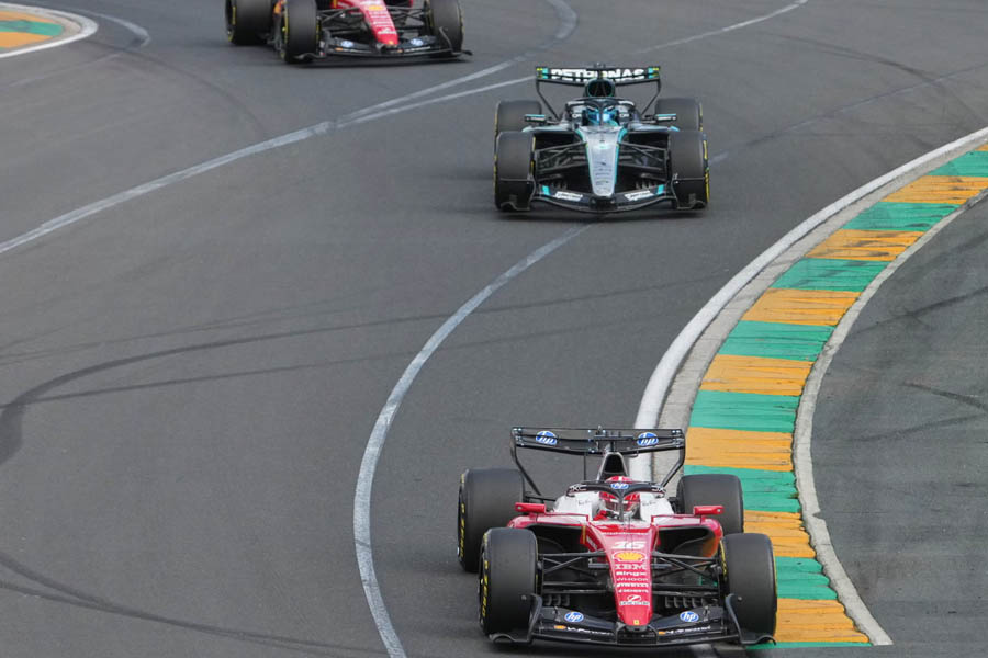 George Russell racing wheel-to-wheel with Ferrari drivers Charles Leclerc and Lewis Hamilton during the intense early battle at the 2026 Australian Grand Prix in Melbourne.