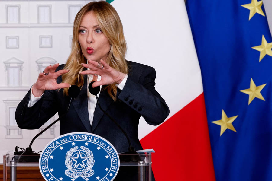 Italian Prime Minister Giorgia Meloni speaks at a press conference at Chigi Palace in Rome, addressing government policy and migration reforms.