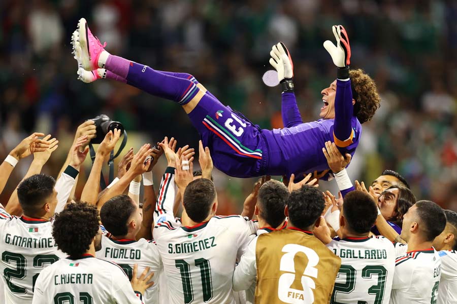 Guillermo Ochoa is tossed into the air by his teammates after Mexico's victory