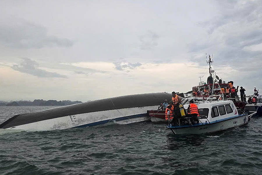 Rescue workers respond at the scene after a tourist boat capsizes during a sudden storm in Vietnam’s Ha Long Bay.