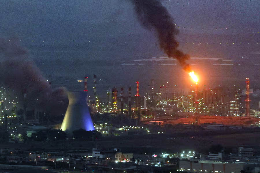Smoke billows from a site in the city of Haifa on Monday after a fresh barrage of Iranian missiles.