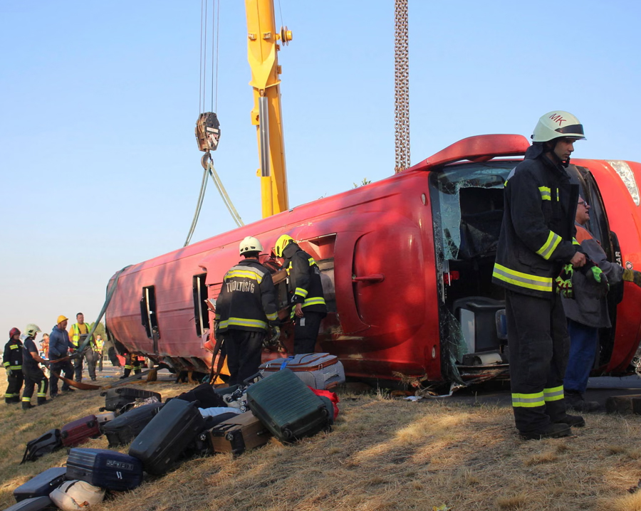 Emergency services at the scene of the crash near the town of Mezőkeresztes. Twelve Polish pilgrims died when their bus overturned on the M3 motorway in Hungary.