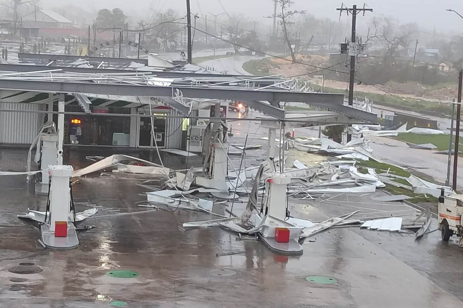 A petrol station severely damaged by Hurricane Melissa in Montego Bay, Jamaica, with debris scattered across the area.