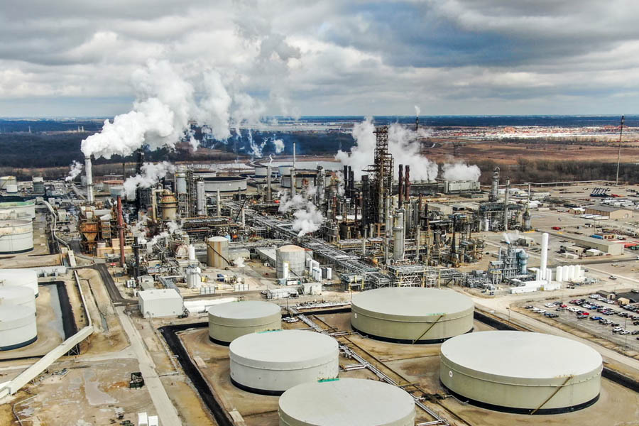 Global oil storage tanks representing emergency crude reserves released by the International Energy Agency to stabilize markets during the energy crisis.