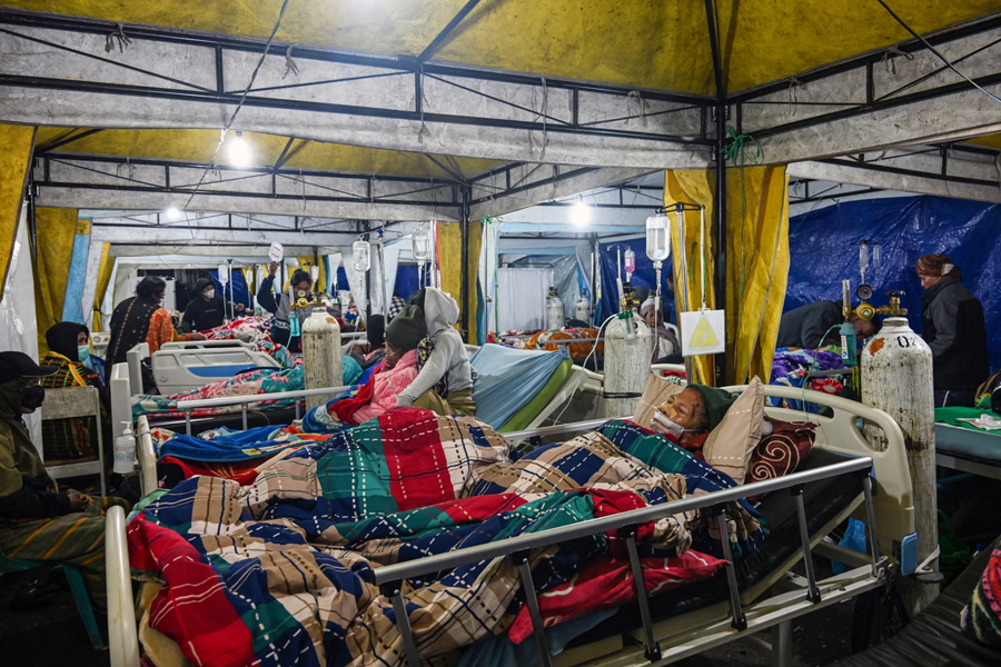 Earthquake victims are treated in a temporary medical tent amid fears of aftershocks in Ruteng