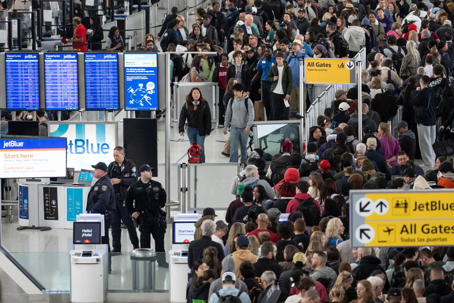 People wait in long security lines at JFK airport in New York as TSA employees call out of work during the partial shutdown of the Department of Homeland Security.