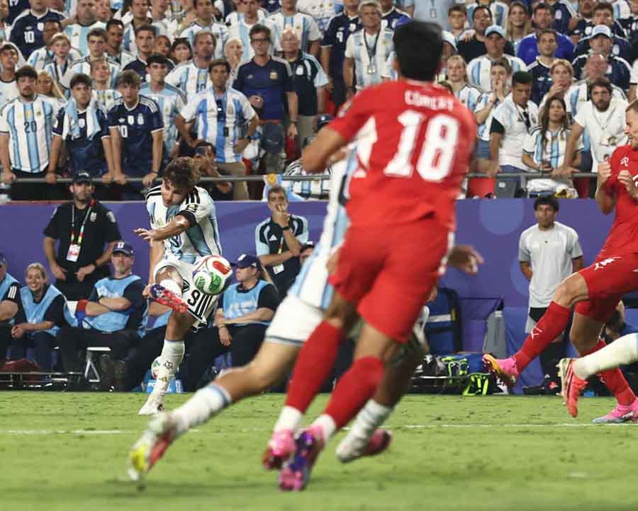 Argentina's Julian Alvarez curls in the second goal against Switzerland