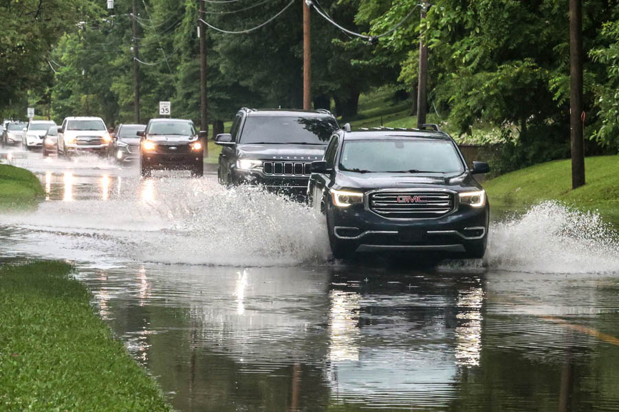 Drivers pass through high water flooding on West Parrish Avenue in Owensboro, Kentucky, after a heavy rainfall on 27 June. The flash floods have claimed four lives across the state.