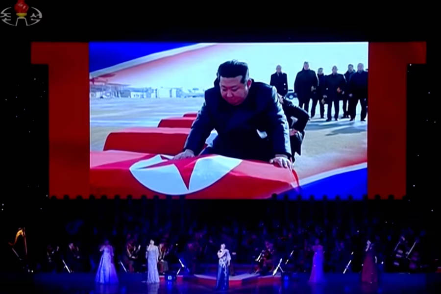 Kim Jong-un on screen honoring fallen soldiers during stage performance in North Korea