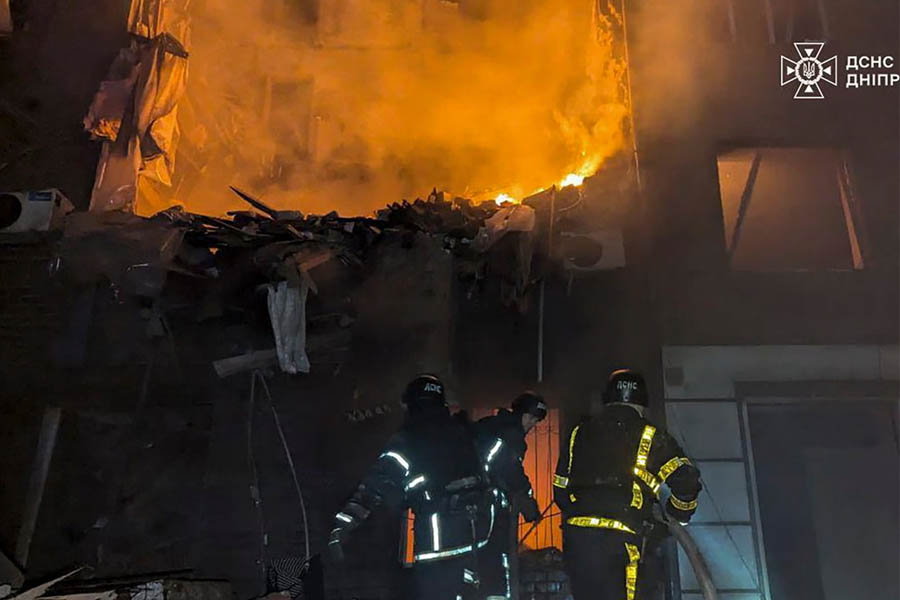 Ukrainian emergency rescuers working at the site of a Russian missile strike on a damaged residential building in Kryvyi Rih, Ukraine.