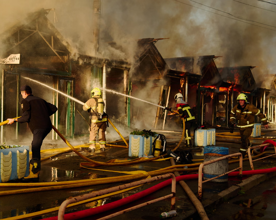 Firefighters work to put out a fire at a book market in Kyiv.