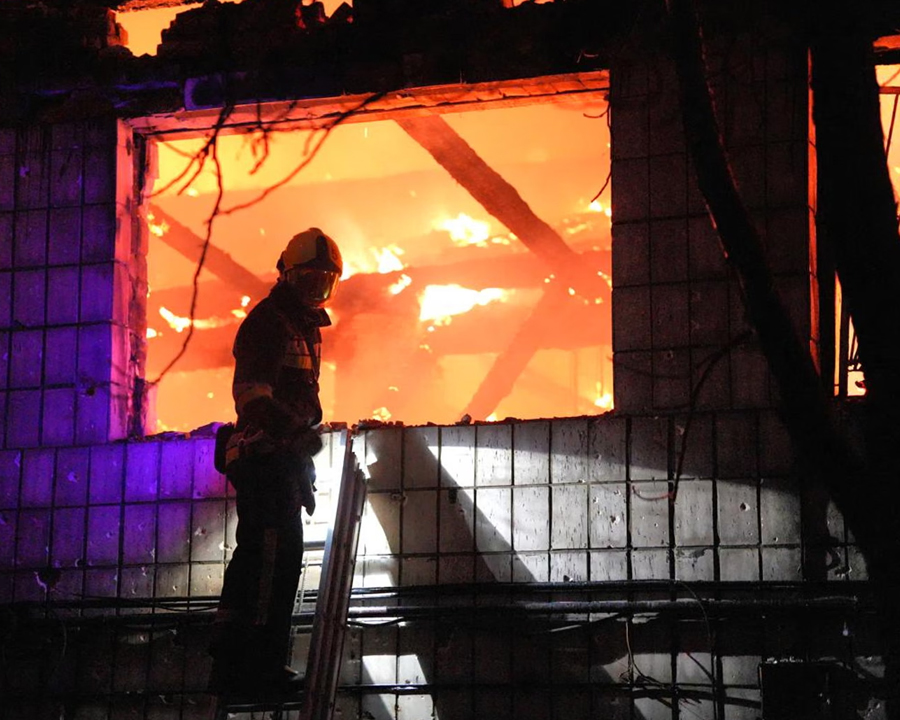 A firefighter responds to a Russian overnight attack on a railway depot in Kyiv.