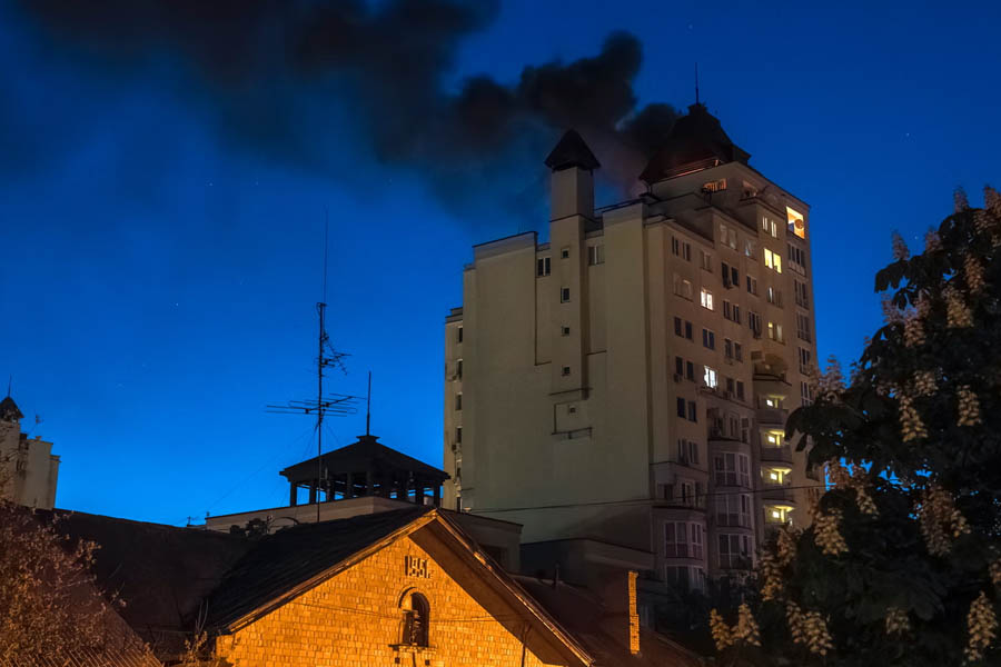 Smoke billows after debris from an intercepted Russian drone fell on the roof of a high-rise residential building in Kyiv, Ukraine.
