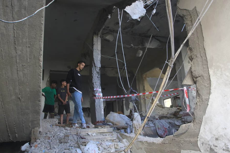 Residents digging through the rubble of a destroyed residential building in Sidon, southern Lebanon, after a dawn Israeli airstrike, with emergency workers and civilians searching for survivors.
